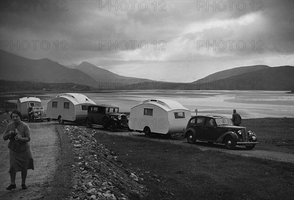 Group of cars and caravans camping in Scottish Highlands 1930's. Creator: Unknown.