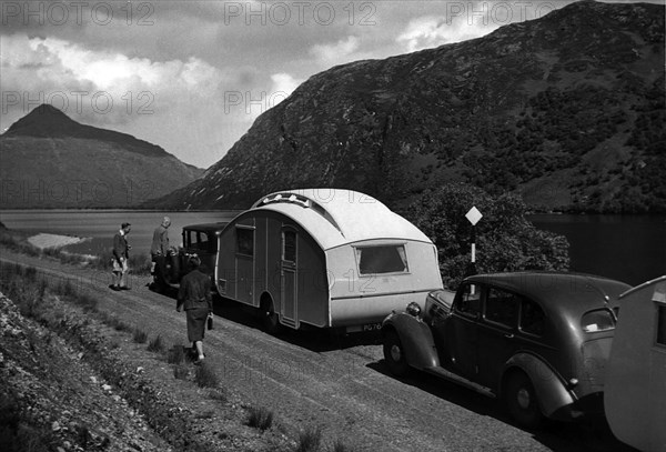 Group of cars and caravans camping in Scottish Highlands 1930's. Creator: Unknown.