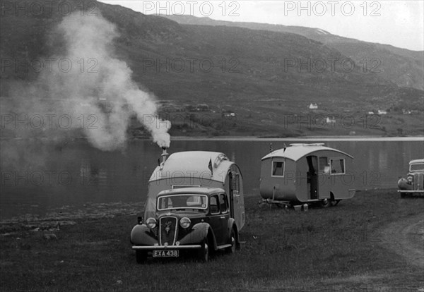 1937 Austin 12hp saloon with caravan. Creator: Unknown.