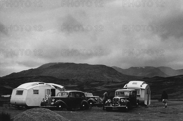 Group of cars and caravans camping in Scottish Highlands 1930's. Creator: Unknown.