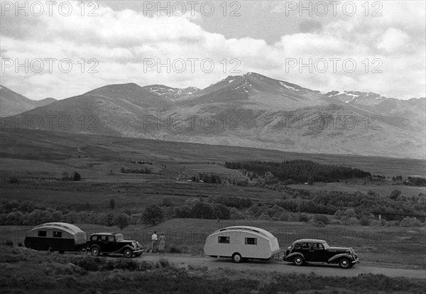 1936 Austin Twenty with caravan and 1936 Oldsmobile Eight with caravan. Creator: Unknown.