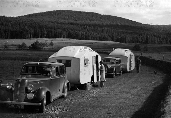 1937 Hillman 14 towing caravan. Creator: Unknown.