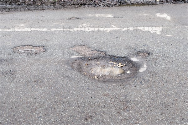 Pot holes in road surface 2017. Creator: Unknown.