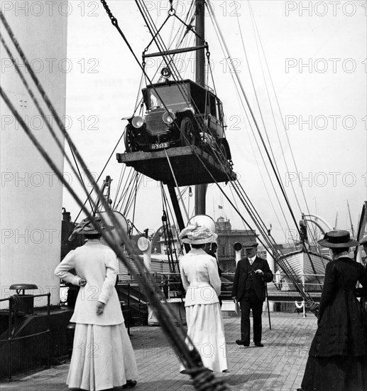 1910 Mercedes being craned onboard ship. Creator: Unknown.