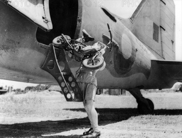 1944 Welbike being placed on to military transport plane. Creator: Unknown.