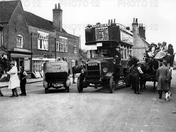 1920's Thornycroft J bus in busy street scene. Creator: Unknown.