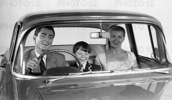 1957 Vauxhall Victor with family together in front seat. Creator: Unknown.