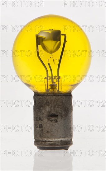 Yellow headlamp bulb. Creator: Unknown.