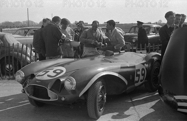 Aston Martin DB3S, Stirling Moss in paddock at Goodwood International Sports Car Race 1956. Creator: Unknown.