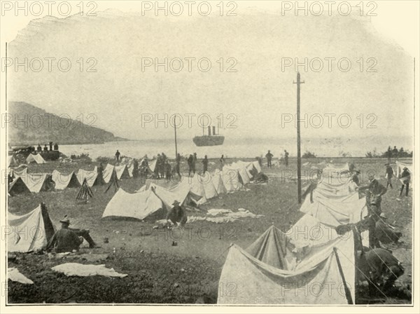 St. Paul in Bay, firing over Top of Hill...June 24th', Spanish-American War, 1898, (1899). Creator: Burr McIntosh.