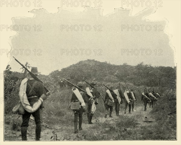 'On the Way from Battlefield of 1st and 10th to "Rough Riders" Scene of Conflict, over the Mountains Creator: Burr McIntosh.