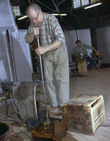 A glass blower at Strombergshyttan's glassworks, Sweden, 1950s. Creator: Unknown.