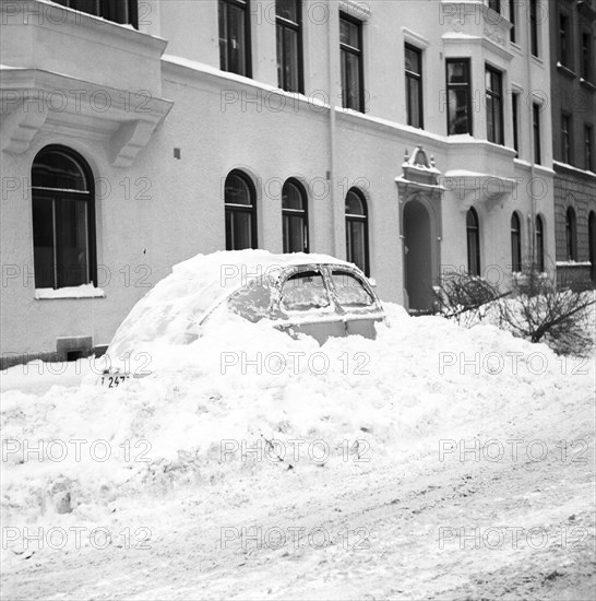 Snow in a car at telephone booth in Stockholm, Sweden, January 1954. Creator: Unknown.