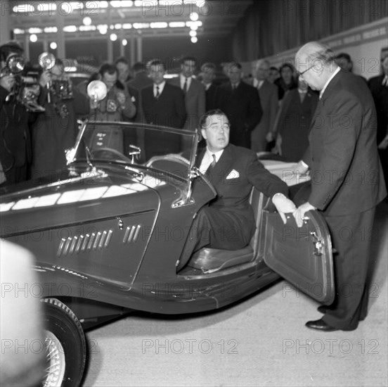 Prince Bertil tests a convertible at the car showroom in Stockholm, Sweden, 1954.  Creator: Unknown.