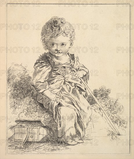 Un enfant assis sur une motte de terre