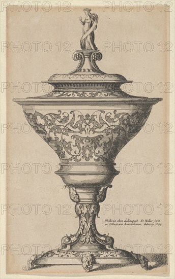 Ornate goblet on feet of masks