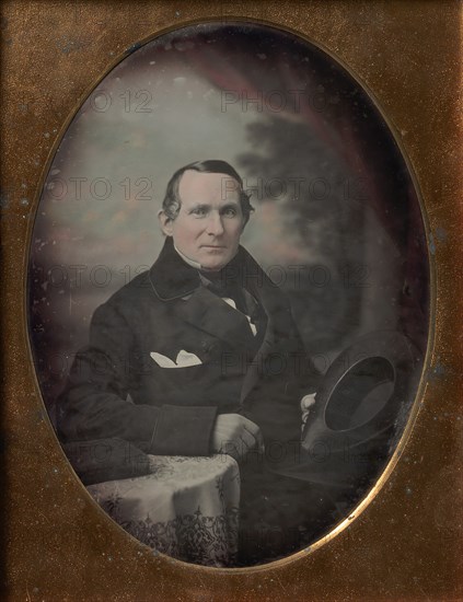 Man Wearing Coat and Gloves, Holding Hat, Seated in Front of Painted Outdoor Backdrop, 1840s.