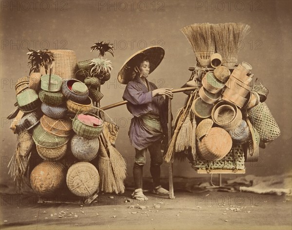 [Japanese Man Posing with Baskets, Brooms and Feather Dusters], 1870s.