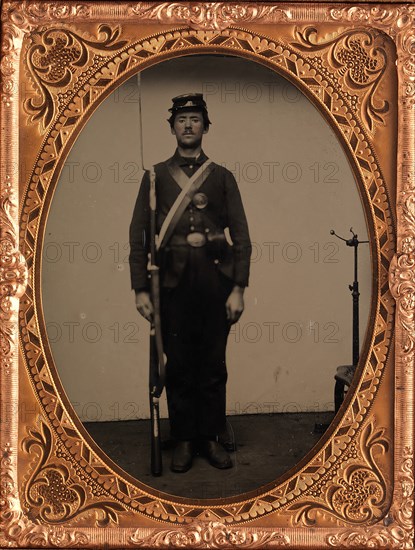 [Union Soldier Holding Rifle, with Photographer's Posing Stand], 1861-65.
