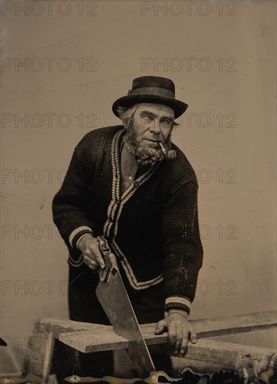 Carpenter Sawing a Plank of Wood, 1880s-90s.