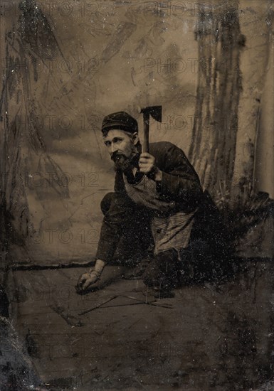 [Kneeling Carpenter Holding a Nail and Raised Hammer], 1870s-80s.