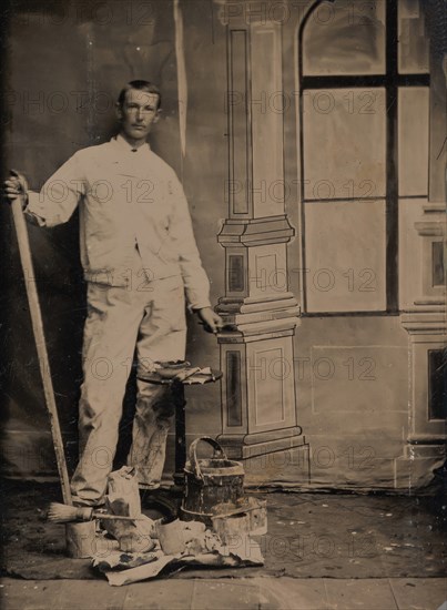 [Painter, Standing in Front of a Painted Window Backdrop, with Brushes, Bucket, and Paint Cans], 1870s-80s.