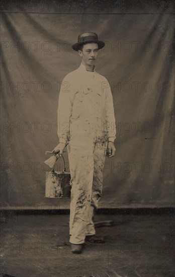 Painter in Paint-spattered Overalls with Brushes and Paint Can, 1870s-80s.