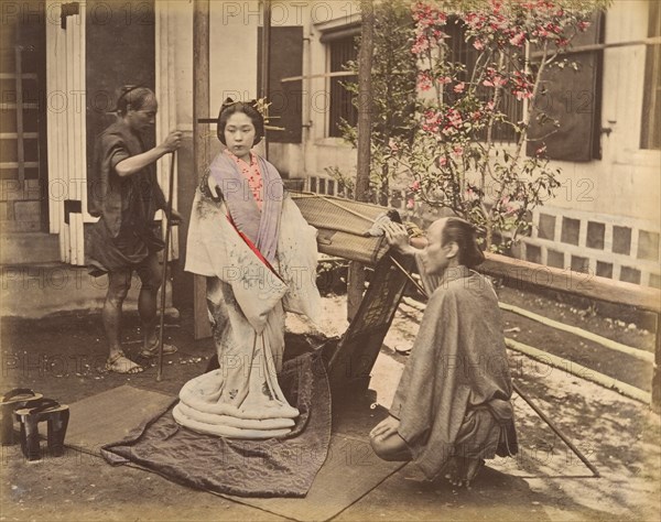 [Japanese Woman in Traditional Dress Posing with Two Men], 1870s.