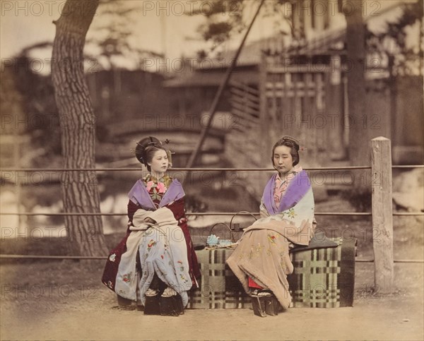 [Two Japanese Women Sitting on a Bench], 1870s.