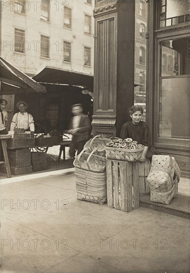 Lena Lochiavo - 11 years old, basket (and pretzel) seller, at Sixth Street Market in front of saloon entrance, Cincinnati, Ohio, 3136.