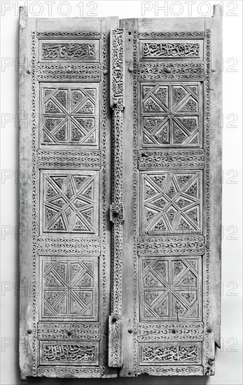 Pair of Carved Doors, Iran, dated A.H. [8]70/ A.D.1466. Teak doors with inscriptions in naskhi script with name of the patron, Davud ibn Ali Davud, and the artist, Ustad Muhammad,