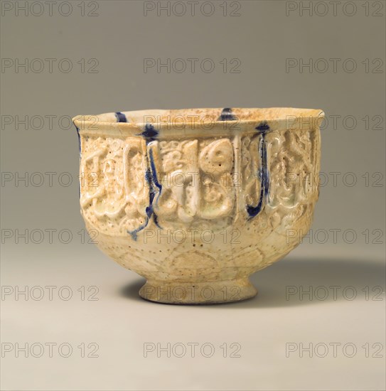 Pierced Bowl Signed by Hasan al-Qashani, Iran, late 11th-early 12th century. Auspicious words 'glory, prosperity, blessed power, and mercy to its owner' are inscribed in cursive script