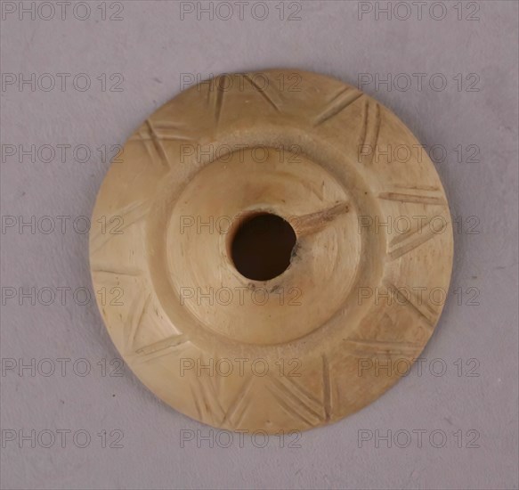 Spindle Whorl, Iran, 9th-10th century.  Excavated at Nishapur, providing evidence the city possessed a thriving textile industry.