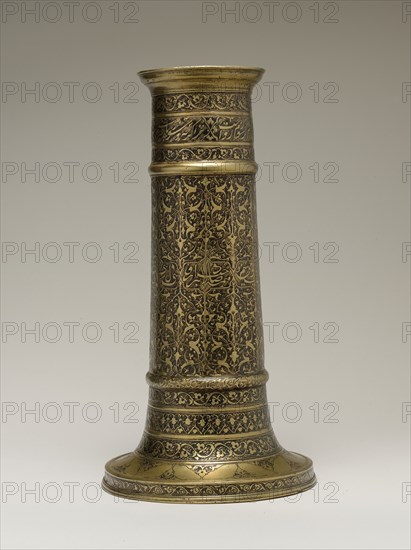 Engraved Lamp Stand with a Cylindrical Body, Iran, second half 16th century. Safavid lamp stand with inscriptions in Persian nasta?liq script, which contain lines from the poem "The Moth and The Candle" by Saadi