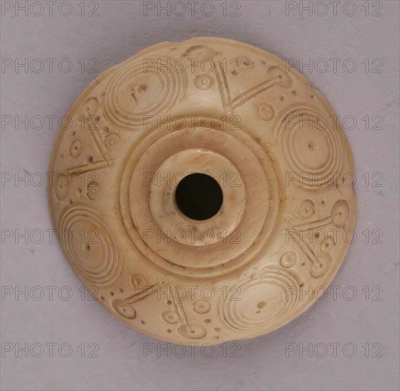 Spindle Whorl, Iran, 9th-10th century.  Excavated at Nishapur, providing evidence the city possessed a thriving textile industry