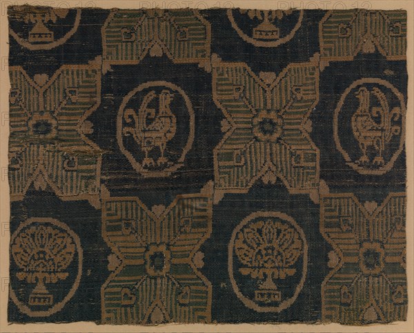 Textile Fragment, probably Iran, 8th-9th century. Four-pointed stars, in between  roundels bearing stylized florals and birds.