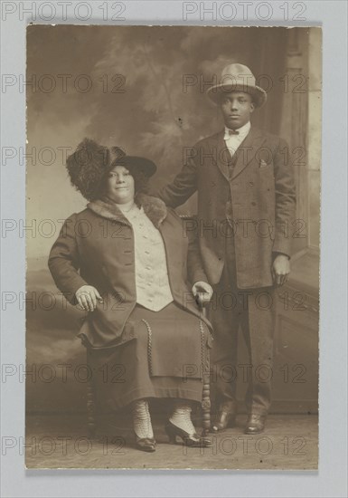 Photographic print of a woman sitting and a man standing, ca. 1850-1895. Creator: Unknown.