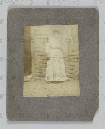 Photographic print of a woman in front of a building, late 19th century. Creator: Unknown.