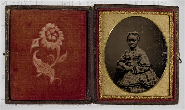 Tintype of a girl in a plaid dress, 1870s. Creator: Unknown.