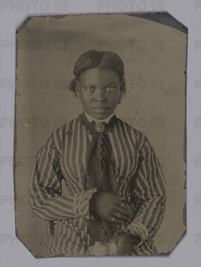 Tintype of young woman in striped dress, Late 1860s. Creator: Unknown.
