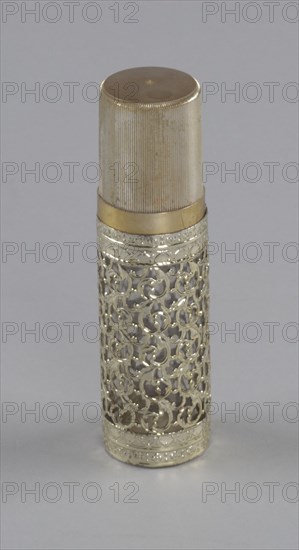 Gold and glass perfume bottle from Mae's Millinery Shop, 1941-1994. Creator: Anne Paree.