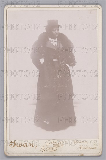 Cabinet card of an unidentified woman wearing a top hat and a fur stole, ca. 1895. Creator: Justus C. Swan.