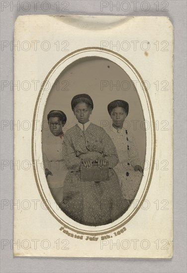 Tintype in a paper case of three unidentified young women seated, 1870s. Creator: Unknown.