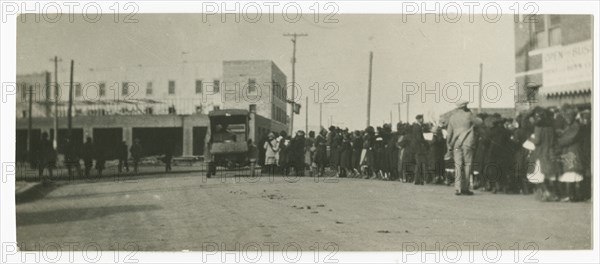 Photograph of people standing in a line on a street in Tulsa, Oklahoma, ca. 1920. Creator: Unknown.