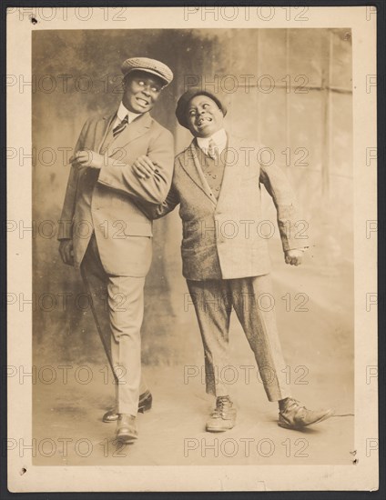 Photograph of two men linking arms, 1910s - 1920s. Creator: The Bell Studio.