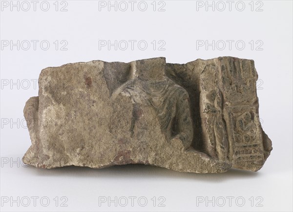 Fragment, showing torso of seated Buddha..., Period of Division, ca. 500. Creator: Unknown.