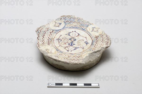 Fragmentary base of a bowl surrounded by wave design, Saljuq period, early 13th century. Creator: Unknown.