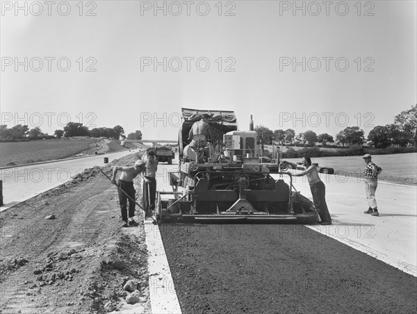 Laing workers operating a paver machine, London to Yorkshire Motorway (M1, 22/07/1959. Creator: John Laing plc.