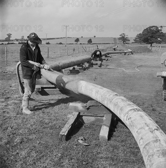 A worker carrying out guniting (spraying concrete) on the Mersey oil pipeline..., 24/09/1967. Creator: John Laing plc.