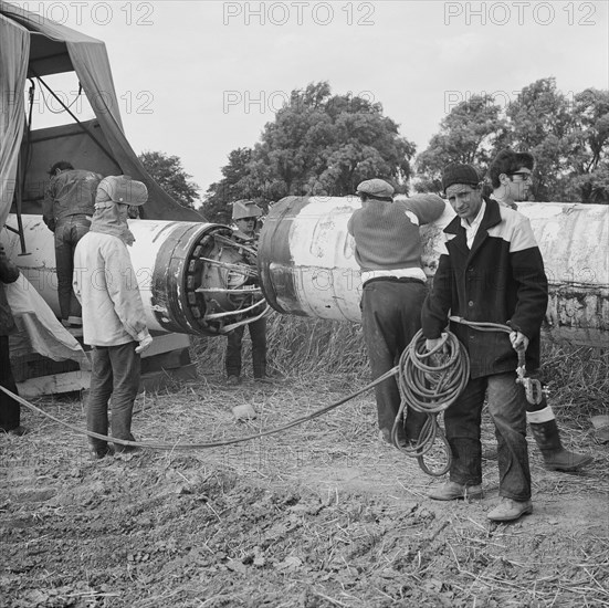 A team of men working on the lining up operation of the Fens gas pipeline, Norfolk, 24/07/1967. Creator: John Laing plc.